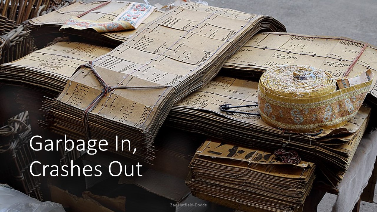 A pile of punched cards for a Jacquard loom, with words 'Garbage in, crashes out'
